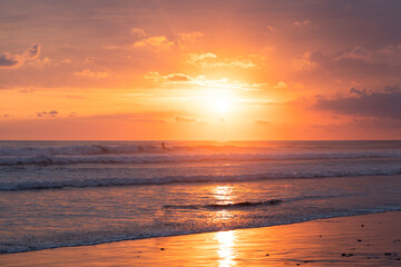 sunset on the beach with surfer