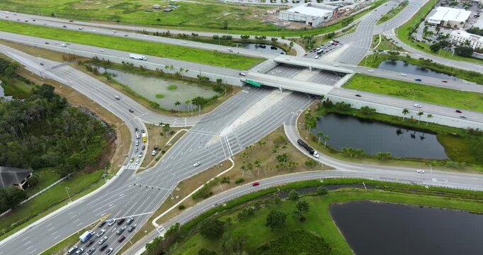 Aerial view of diverging diamond interchange transportation infrastructure in USA city. Wide multilane highway crossroads with fast driving cars in Sarasota, Florida.