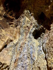 A close-up of a gold vein embedded in rugged rock, showcasing the natural wealth hidden within the earth. A striking image of geology and the allure of precious metals.