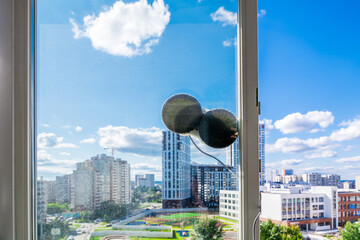 Robot window cleaner washes glass with round rags, robotic service, modern technologies