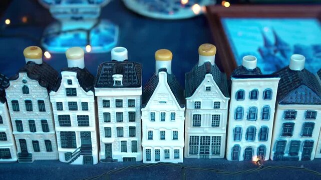 Traditional Dutch Delft Blue miniature houses lined up with glowing fairy lights in the Netherlands