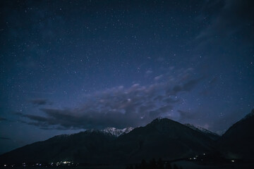 Night landscape in the Tien Shan mountains in Tajikistan in the Pamirs, stars and mountains with...