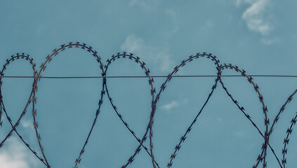 barbed wire on blue sky background