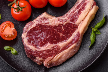 Fresh, raw beef steak with salt, spices and herbs