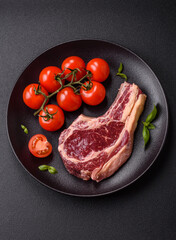 Fresh, raw beef steak with salt, spices and herbs