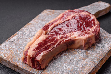 Fresh, raw beef steak with salt, spices and herbs