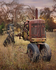 old rusty farm tractor in field