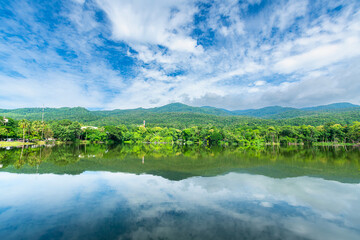 a public place leisure travel landscape lake views at Ang Kaew Chiang Mai University and Doi Suthep nature forest Mountain views spring cloudy sky background with white cloud.