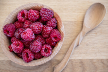 Top view of ripe raspberry on wooden table