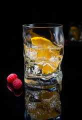 Cocktail with orange slice in dark bar