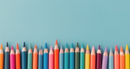 Colorful Collection of Pencils Arranged Neatly on a Light Blue Surface