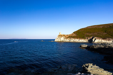 Barcaggio beach and Agnello tower, Cap Corse, Corsica, France.