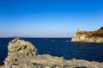 Barcaggio beach and Agnello tower, Cap Corse, Corsica, France.