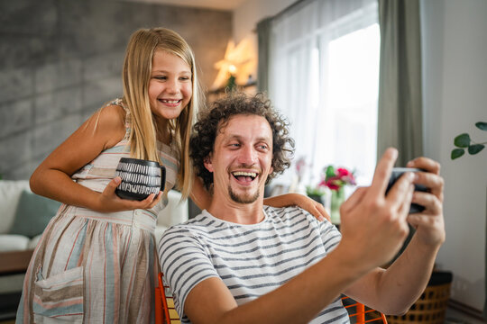 Single father take self portrait or have video call with his daughter
