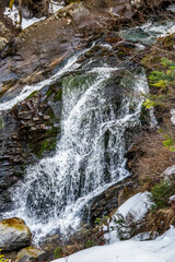 Close view of the Yulenski skok waterfall on mountain Demyanishka river in the early spring. Pirin national park, Bansko, Bulgaria. © Anna