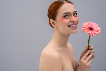 Cheerful young female enjoying skin care routine with patches for facial treatment