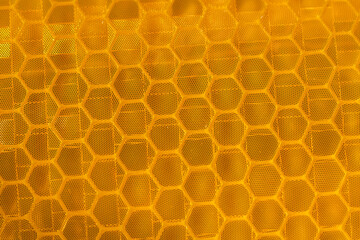 Close-up of orange hexagonal reflective texture
A close-up view of an orange hexagonal reflective pattern, showcasing its geometric design and textured surface in vibrant tones.
