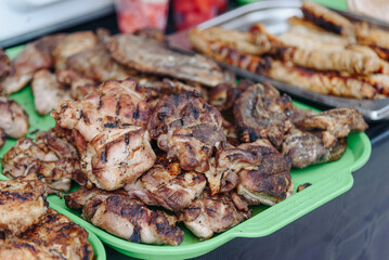 barbecue on skewers on tray in counter in street, grilled meat, street food concept