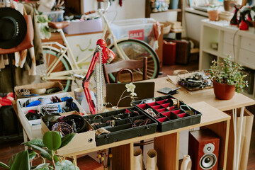 Organizing various accessories in cozy shop interior with jewelry stands, shelves filled with...
