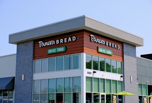 Panera Bread restaurant storefront featuring the store name and drive thru sign