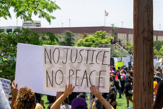 No justice no peace - BLM Protest Sign - person holding protest sign