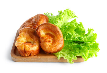 Wooden board with tasty Yorkshire pudding isolated on white background