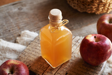 A bottle of apple cider vinegar on a table