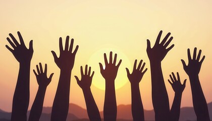 Obraz premium Silhouetted hands raised in unison against a vibrant sunset sky.
