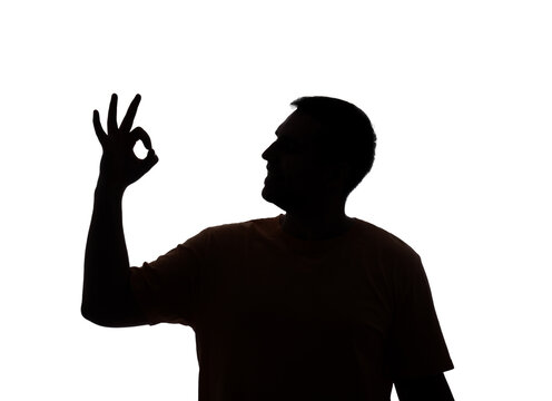 recommend clip art: Silhouette of young man showing OK gesture on white background