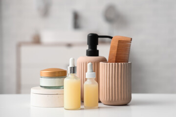 Set of cosmetic products on table in bathroom