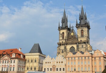 European city with a gothic church and colorful buildings in the old town square.