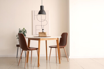 Wicker mat, books and aroma diffuser on table in interior of living room
