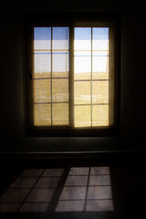 An Image of a Open Window and shadow on ground
