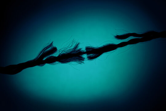 Silhouette of Breaking rope on Turquoise background.