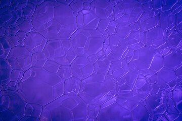 Macro shot of Soap foam texture on blue and purple background.