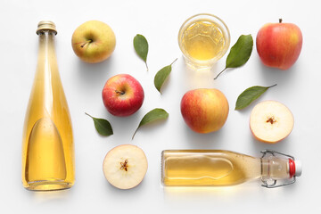 Composition with fruits, bottles and glass of fresh apple cider on white background