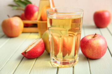 Composition with fruits and glass of fresh tasty apple cider on green wooden table, closeup