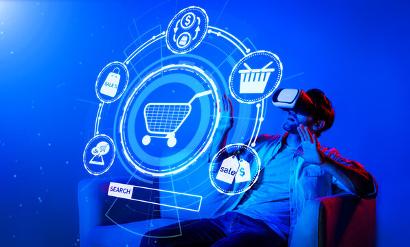 Happy man using VR headset and shopping online while sitting at sofa with shopping bags. Smart person looking at online market hologram and icon with neon background. Innovation technology. Deviation.