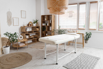 Interior of spa salon with couch, tables and shelf units