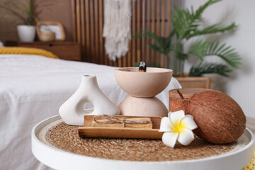Bowl with Palo Santo, flower and coconut on table in bedroom, closeup