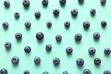 Many ripe blueberry on turquoise background
