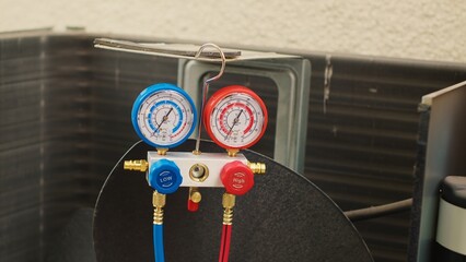 Close up of manifold meters used for checking air conditioner freon in need of service. Set of...