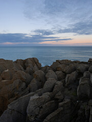 Layered rock formation at the shore.