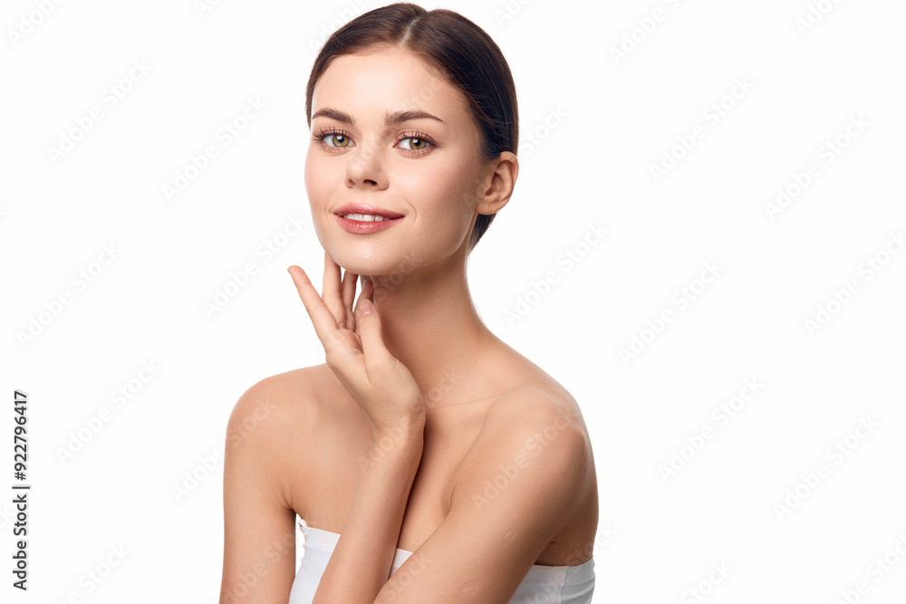 Wall mural Beautiful young woman with hands on face, posing on white background