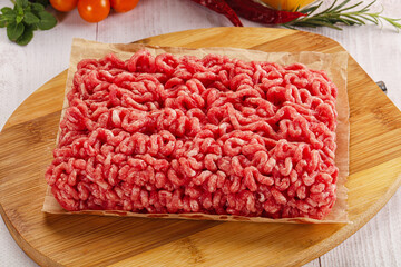 Raw minced beef meat over board