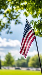 Patriotic Tribute: American Flag Waves Gracefully at a Military Cemetery on National Holidays, Honoring Heroes on Veterans Day and Memorial Day.
