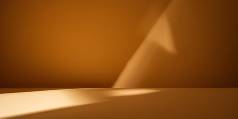 Light background. Sunlight in triangle shape and shadow on brown wall. Product display.