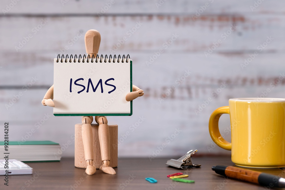 Aufkleber there is notebook with the word isms. it is an abbreviation for information security management syst
