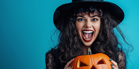 Fototapeta premium A woman in a witch hat expressing excitement while holding a jack-o'-lantern, perfect for Halloween celebrations