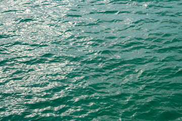 Abstract blue sea water. Background texture. Water in swimming pool or sea. Rippled water detail background. Blue sea surface.